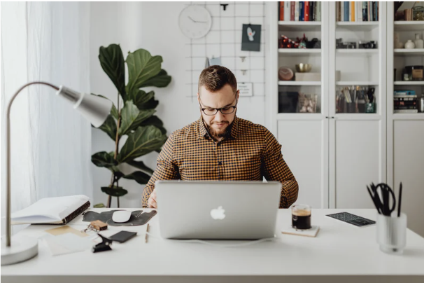Focused adult working in natural morning light, representing improved concentration with magnesium L-threonate.