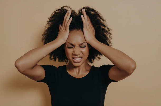 Young woman feeling stressed and fatigued, representing magnesium depletion and chronic stress impact on mood.