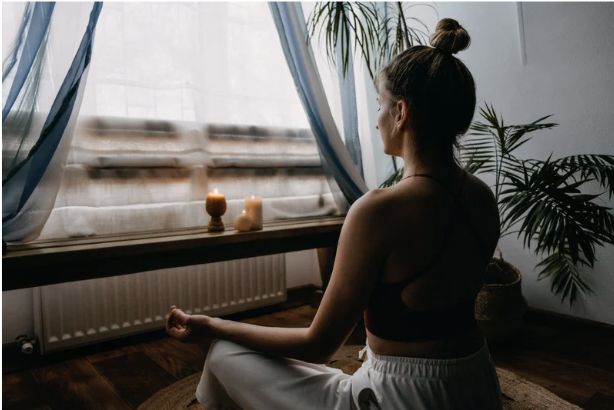 Woman meditating indoors showing relaxation and mindfulness supported by magnesium for stress management.