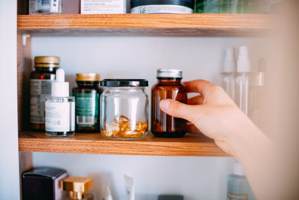 Hand reaching up to magnesium supplement for supporting brain health and neuroplasticity.