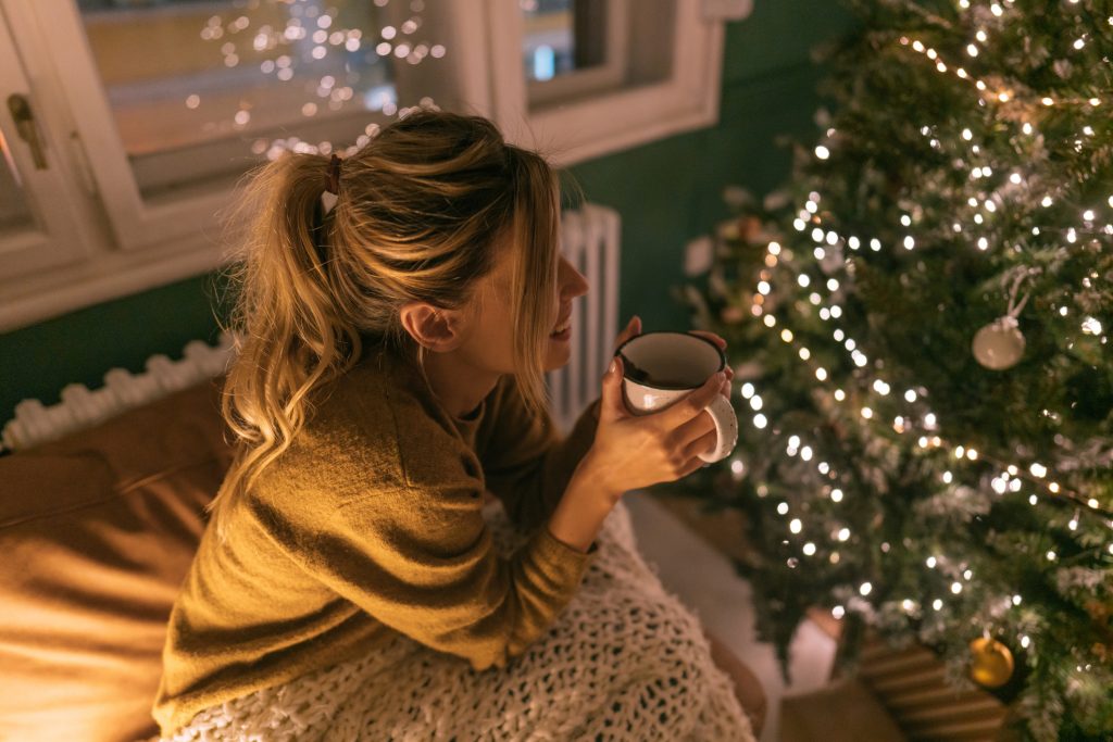 Woman practicing mindfulness to support emotional resilience during the holiday season.